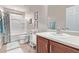 Bathroom featuring a shower-tub combo, a framed mirror, and stylish fixtures at 7946 W Sonoma Way, Florence, AZ 85132