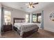 Spacious bedroom filled with natural light, a ceiling fan, and sliding door to the patio at 7946 W Sonoma Way, Florence, AZ 85132