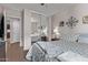 Bedroom featuring a mirrored closet, ceiling fan, and a comfortable bed with stylish bedding at 7946 W Sonoma Way, Florence, AZ 85132