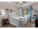 Cozy bedroom featuring a ceiling fan, window with curtains, and comfortable furnishings at 7946 W Sonoma Way, Florence, AZ 85132