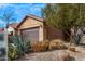 Home showcasing a well-maintained xeriscaped front yard with desert landscaping and mature shrubbery at 7946 W Sonoma Way, Florence, AZ 85132