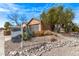 Property exhibiting a xeriscaped front yard with desert landscaping, rocks, and mature shrubs at 7946 W Sonoma Way, Florence, AZ 85132