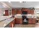 Open concept kitchen with plenty of counter space, a sink, and all black appliances at 7946 W Sonoma Way, Florence, AZ 85132