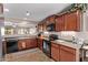 This kitchen features wood cabinets, modern appliances, and a view of the patio at 7946 W Sonoma Way, Florence, AZ 85132