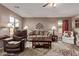 Comfortable living room with hardwood floors, ceiling fan, and neutral decor at 7946 W Sonoma Way, Florence, AZ 85132