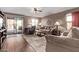 Inviting living room featuring hardwood floors, comfortable seating, and natural light at 7946 W Sonoma Way, Florence, AZ 85132