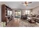 Cozy living room with hardwood floors, a ceiling fan, and access to the backyard patio at 7946 W Sonoma Way, Florence, AZ 85132