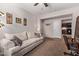 Spacious living room with a comfortable sofa, neutral walls, and a view into the kitchen at 7946 W Sonoma Way, Florence, AZ 85132