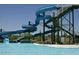 View of the pool's twisting blue waterslides next to the pool, and the metal staircase and support structure at 7946 W Sonoma Way, Florence, AZ 85132