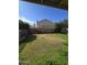 Lawn view of backyard showcasing privacy block fence, mature trees, and grass at 849 W Spur Ave, Gilbert, AZ 85233