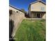 Backyard view of grass area and home's exterior at 849 W Spur Ave, Gilbert, AZ 85233