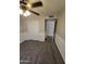 A cozy bedroom featuring carpet, a ceiling fan, and a closet with sliding doors at 849 W Spur Ave, Gilbert, AZ 85233