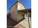 Exterior view of the home showcasing the covered patio and a glimpse of the well-maintained yard at 849 W Spur Ave, Gilbert, AZ 85233