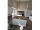 Bright kitchen featuring granite countertops, white cabinets, and a view into the adjacent living space at 849 W Spur Ave, Gilbert, AZ 85233