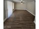 Spacious living room featuring wood-look floors, a ceiling fan, and large windows providing ample natural light at 849 W Spur Ave, Gilbert, AZ 85233