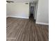 Open living room featuring modern wood-look floors and a neutral color scheme at 849 W Spur Ave, Gilbert, AZ 85233