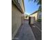 Pathway between houses leading to the backyard, providing easy access and enhancing curb appeal at 849 W Spur Ave, Gilbert, AZ 85233