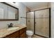 Bathroom with glass shower door and granite countertops at 8608 E Vernon Ave, Scottsdale, AZ 85257