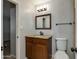 Bathroom with wood cabinets and a granite countertop at 8608 E Vernon Ave, Scottsdale, AZ 85257