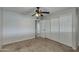 Bedroom with beige carpet, ceiling fan, and double door closet at 8608 E Vernon Ave, Scottsdale, AZ 85257