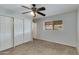 Cozy bedroom features neutral carpet, standard closet, and window at 8608 E Vernon Ave, Scottsdale, AZ 85257