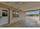 Covered carport showcasing durable brick construction, featuring a side door and an external window at 8608 E Vernon Ave, Scottsdale, AZ 85257