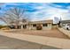 A cozy single-story house boasting a well-maintained front yard with desert landscaping and a covered carport at 8608 E Vernon Ave, Scottsdale, AZ 85257