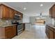 Modern kitchen featuring stainless steel appliances, wooden cabinetry, and tiled flooring at 8608 E Vernon Ave, Scottsdale, AZ 85257