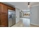 View of kitchen and living space features stainless steel refrigerator and large window at 8608 E Vernon Ave, Scottsdale, AZ 85257