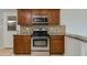 Close up of kitchen featuring stainless steel oven and range beneath built in microwave at 8608 E Vernon Ave, Scottsdale, AZ 85257