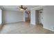 Spacious living room featuring tile flooring, neutral walls, ceiling fan, and a seamless flow to adjoining rooms at 8608 E Vernon Ave, Scottsdale, AZ 85257