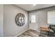 Inviting entryway with hardwood-style floors, designer clock, and decorative glass door at 901 W Parkway Blvd, Tempe, AZ 85281