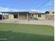 Large backyard with artificial turf, gravel, and a covered patio area at 9023 N 18Th Ave, Phoenix, AZ 85021