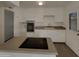 Clean kitchen featuring white cabinets and a modern cooktop on the kitchen island at 9023 N 18Th Ave, Phoenix, AZ 85021