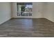 Clean, freshly painted living room with hardwood floors and a bright view through the window at 9023 N 18Th Ave, Phoenix, AZ 85021