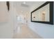 Bright hallway with neutral tones, a large mirror, and tiled flooring at 921 W Peralta Pass, Apache Junction, AZ 85120