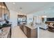 Open kitchen featuring a large island and stainless steel appliances, flowing into the living area at 921 W Peralta Pass, Apache Junction, AZ 85120