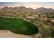 Scenic aerial view of a luxury home, featuring a golf course, and desert landscaping at 9290 E Thompson Peak Pkwy # 142, Scottsdale, AZ 85255