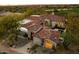 An aerial view showcases a luxury home featuring red tile roof, manicured landscaping, and stunning architectural details at 9290 E Thompson Peak Pkwy # 142, Scottsdale, AZ 85255