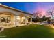 Inviting covered patio with lawn and well-manicured landscaping, perfect for entertaining guests and enjoying evenings at 9290 E Thompson Peak Pkwy # 142, Scottsdale, AZ 85255