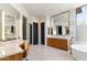 Bathroom featuring dual vanities, and modern fixtures, and soaking tub at 9290 E Thompson Peak Pkwy # 142, Scottsdale, AZ 85255