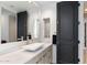 Bathroom features sleek vanity with marble countertop, modern fixtures, and black paneled door at 9290 E Thompson Peak Pkwy # 142, Scottsdale, AZ 85255