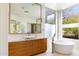 Bright bathroom features modern vanity, soaking tub, and large window with scenic outdoor views at 9290 E Thompson Peak Pkwy # 142, Scottsdale, AZ 85255