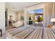 Bright bedroom featuring a patio view through sliding glass doors and a sitting area with neutral tones at 9290 E Thompson Peak Pkwy # 142, Scottsdale, AZ 85255