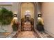 Inviting wrought iron gated entrance featuring stone accents and elegant lighting at 9290 E Thompson Peak Pkwy # 142, Scottsdale, AZ 85255