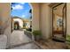 Inviting entryway with stone walkway leading to an arched doorway and a glimpse of the interior at 9290 E Thompson Peak Pkwy # 142, Scottsdale, AZ 85255