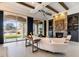 Inviting living room with a stone fireplace, wood beamed ceiling, and bright light from large windows at 9290 E Thompson Peak Pkwy # 142, Scottsdale, AZ 85255