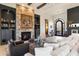 Comfortable living room with a stone fireplace, built-in shelving, and large windows for natural light at 9290 E Thompson Peak Pkwy # 142, Scottsdale, AZ 85255