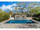 A refreshing pool area with a stone water feature, lush landscaping, and ample patio space at 9290 E Thompson Peak Pkwy # 142, Scottsdale, AZ 85255