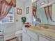 Cozy bathroom with window, vanity with marble countertop and decorative accents at 9313 W Arrowhead Dr, Sun City, AZ 85351